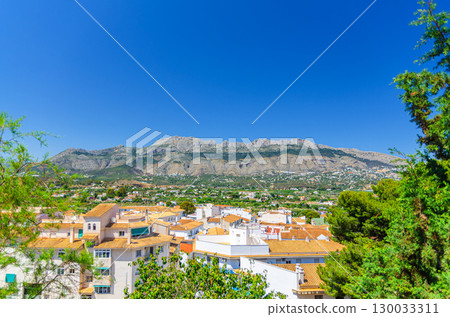 Altea old town aerial view with typical white houses traditional buildings red tiled roofs, Bernia mountain range in sunny day, Altea city historical centre Casco Antiguo, Alicante province, Spain 130033311