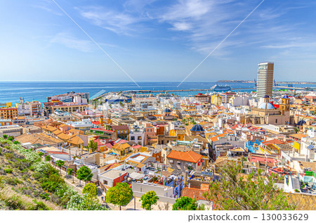 Aerial panoramic view of old town Alicante with buildings, panorama of Alicante city historical centre, Port of Alicante seaport in Alicante bay of Mediterranean Sea, Valencian Community, Spain 130033629