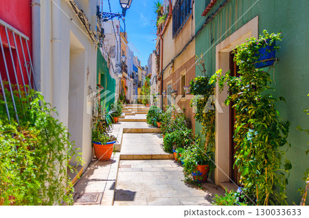 Alicante old town San Roque quarter, narrow street with typical houses, traditional colorful buildings, flowers and plants, Casco Antiguo Alicante city historical centre, Valencian Community, Spain 130033633