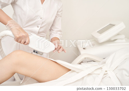 Professional laser hair removal procedure for female client in beauty clinic Professional laser hair removal procedure for female client in beauty clinic 130033702