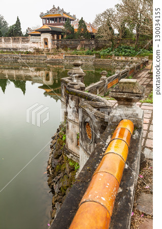 View across historic moat with stone railing in Hue Imperial City Vietnam 130034155