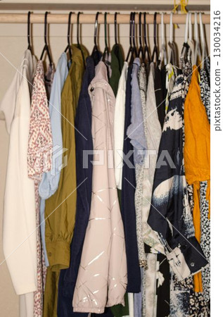 Wardrobe with Assorted Clothes Hanging on Hangers Wardrobe with Assorted Clothes Hanging on Hangers 130034216
