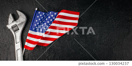 Concept of Labor Day in America with wrench and patriotic flag. Long banner format. top view. copy space Concept of Labor Day in America with wrench and patriotic flag. Long banner format. top view. copy space 130034237