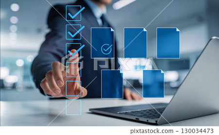 A businessman touches a check box and touches a touch panel with his finger A businessman touches a check box and touches a touch panel with his finger 130034473