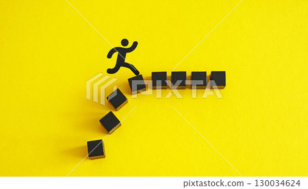 Person jumping over obstacles made of blocks. Personal growth. 130034624