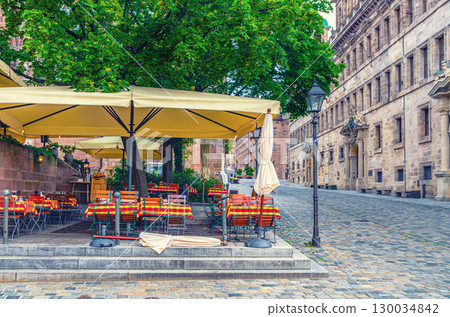 Street restaurant outdoor cafe on empty pedestrian Town Hall square Rathausplatz, City Hall medieval building Rathaus in Old town Nuremberg city historical center, Middle Franconia region, Germany 130034842
