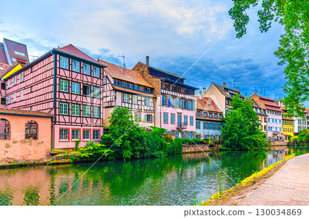 The Petite France Quarter Quartier des Tanneurs, quay embankment promenade of River Ill canal with colorful houses buildings old town Strasbourg city historic Centre, Alsace Grand Est region, France The Petite France Quarter Quartier des Tanneurs, quay embankment promenade of River Ill canal with colorful houses buildings old town Strasbourg city historic Centre, Alsace Grand Est region, France 130034869