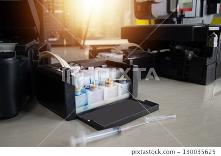 Side view of the printer and ink tank 130035625