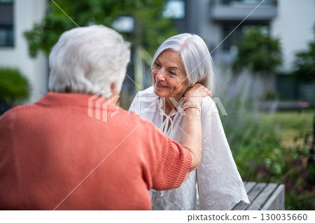 Tender moment between elderly mother and adult daughter Tender moment between elderly mother and adult daughter 130035660