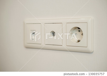 Triple outlet on textured white wall consists of internet port, coaxial cable port and power outlet. Suitable for home improvement, telecommunications, electricity topics Triple outlet on textured white wall consists of internet port, coaxial cable port and power outlet. Suitable for home improvement, telecommunications, electricity topics 130035757