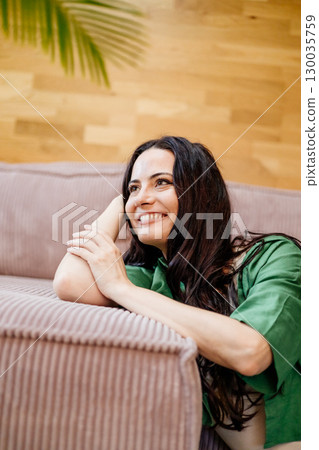 Confident woman taking a break, casual home portrait. 130035759
