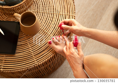 Close-up of female doing pedicure on toes. 130035781