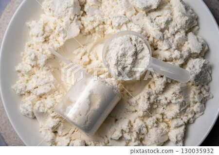 Protein whey powder with scoops. Food supplement, bodybuilding, fitness and gym lifestyle.  130035932