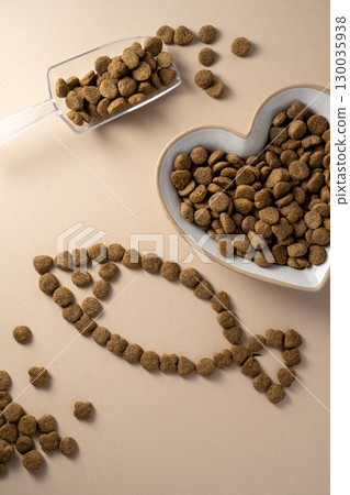 Pet food. Dry cat food in heart shaped bowl. Nutrition for pets, top view. Pet food. Dry cat food in heart shaped bowl. Nutrition for pets, top view. 130035938