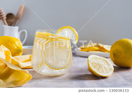 Refreshing lemon water in a glass on the table Refreshing lemon water in a glass on the table 130036133
