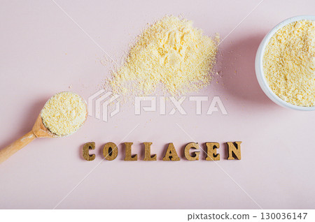 Close up of collagen powder in a bowl and spoon and a glass of water on the table top view Close up of collagen powder in a bowl and spoon and a glass of water on the table top view 130036147