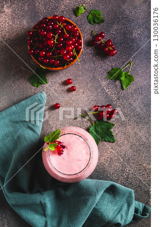 Red currant soy milk smoothie in glass on table top and vertical view Red currant soy milk smoothie in glass on table top and vertical view 130036176