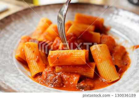 Tourists eating authentic Roman amatriciana Tourists eating authentic Roman amatriciana 130036189
