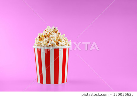 Classic red striped popcorn cardboard cup on Pink background Classic red striped popcorn cardboard cup on Pink background 130036623