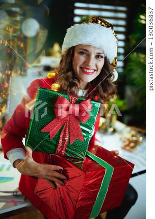 business owner woman in green office with Christmas tree 130036837