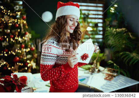 business owner woman in green office with Christmas tree 130036842