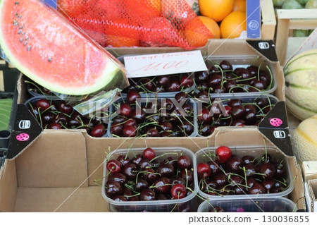Fresh cherries and watermelon slice at farmers market stall 130036855