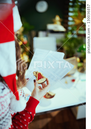 Business owner woman in green office with Christmas tree Business owner woman in green office with Christmas tree 130036857