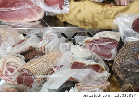 Vacuum packed cured meats displayed on market stall Vacuum packed cured meats displayed on market stall 130036887