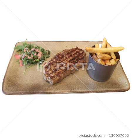Grilled striploin steak served with french fries and salad on rectangular plate 130037003