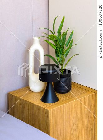 Art and plant on night table 130037320