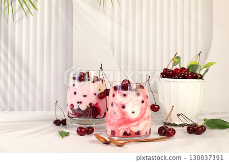 Fruit yogurt with cherries and fresh cow cream for healthy nutrition in a glass on an elegant table. Healthy breakfast with ingredients, kitchen background. Natural food and detox diet concept, 130037391