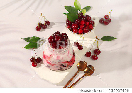 Cherry yogurt with berries in a glass on an elegant table, fruit salad, detox diet and natural nutrition concept, healthy breakfast with ingredients.advertisement of a healthy lifestyle 130037406
