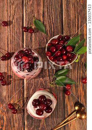 Cherry yogurt with berries in a glass on an elegant table, fruit salad, detox diet and natural nutrition concept, healthy breakfast with ingredients.advertisement of a healthy lifestyle 130037413