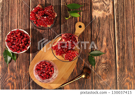 Pomegranate yogurt with berries in a glass on an elegant table, fruit salad, detox diet and natural nutrition concept, healthy breakfast with ingredients.advertisement of a healthy lifestyle Pomegranate yogurt with berries in a glass on an elegant table, fruit salad, detox diet and natural nutrition concept, healthy breakfast with ingredients.advertisement of a healthy lifestyle 130037415