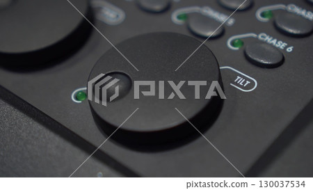 Close-up of finger adjusting Tilt shuttle on lighting console Close-up of finger adjusting Tilt shuttle on lighting console 130037534