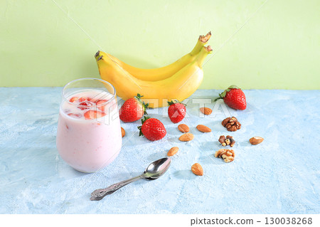 Strawberry and banana smoothies with berries and banana on a bright table. Useful breakfast made with ingredients. Healthy and natural food concept, lifestyle, selective focus, place for text Strawberry and banana smoothies with berries and banana on a bright table. Useful breakfast made with ingredients. Healthy and natural food concept, lifestyle, selective focus, place for text 130038268