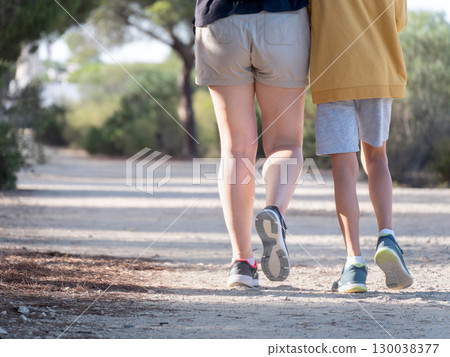 Mother and Child Walk on a Sunny Nature Trail 130038377