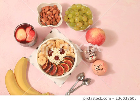 Healthy breakfast with ingredients, fun food for kids. The concept of healthy and natural food. Cottage cheese with figs and bananas, nuts and grapes, top view, selective focus. 130038605