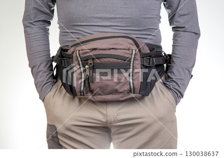 Practical waist bag worn by a person in casual attire, ideal for outdoor activities 130038637