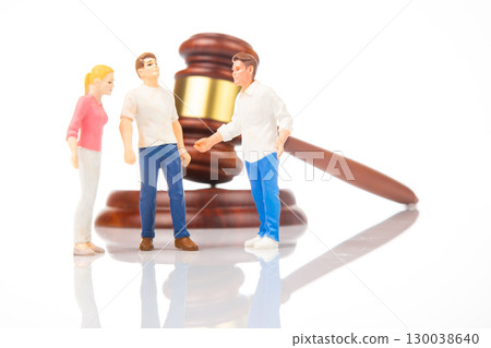 Miniature figures discussing legal matters near a gavel Miniature figures discussing legal matters near a gavel 130038640