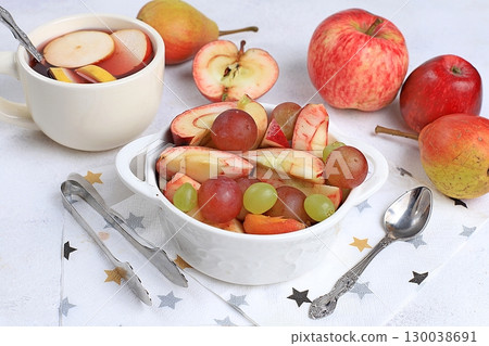 Fruit salad, healthy breakfast with ingredients, yogurt with muesli, apples, pears and grapes on a light table. The concept of healthy and natural food, lifestyle. selective focus Fruit salad, healthy breakfast with ingredients, yogurt with muesli, apples, pears and grapes on a light table. The concept of healthy and natural food, lifestyle. selective focus 130038691