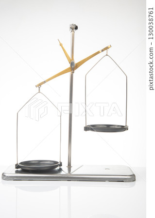 Balance scale positioned for precise measurements in a bright studio setting 130038761