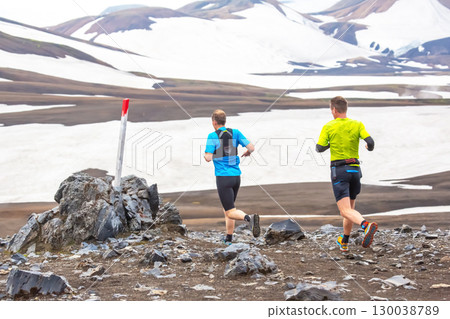 Runners navigate rocky terrain in Iceland stunning landscape during summer 130038789