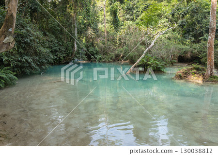 Kuang Si Waterfall flowing into a clear blue forest river in Luang Prabang, Laos Kuang Si Waterfall flowing into a clear blue forest river in Luang Prabang, Laos 130038812
