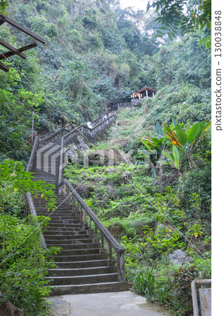 Jang Cave, Vang Vieng, Laos,Stone staircase ascending through lush forest to small mountain pavilion  in Luang Prabang, Laos 130038848