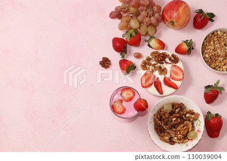 Useful breakfast, food for children, strawberry yogurt and granola, on a bright table. The concept of healthy and natural food. selective focus Useful breakfast, food for children, strawberry yogurt and granola, on a bright table. The concept of healthy and natural food. selective focus 130039004