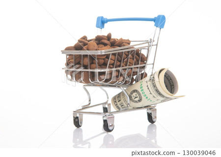 Miniature shopping carts filled with coffee beans and dollar bills  130039046