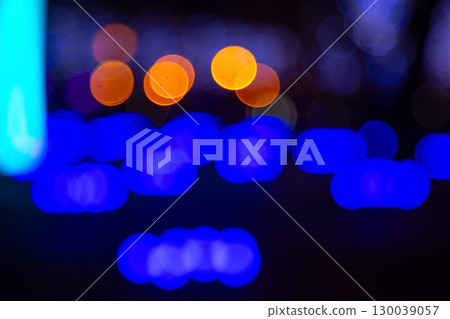 Abstract golden and vibrant light bokeh on a dark backdrop 130039057
