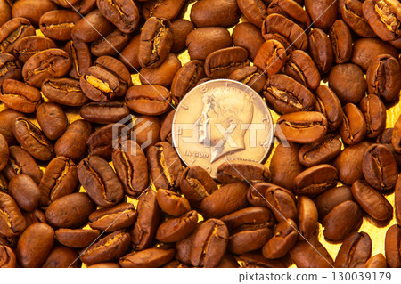 Close-up of roasted coffee beans surrounding a dime Close-up of roasted coffee beans surrounding a dime 130039179
