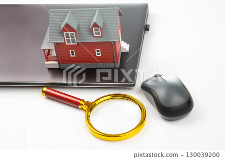 Finding and buying a home over the Internet. House model on the background 130039200